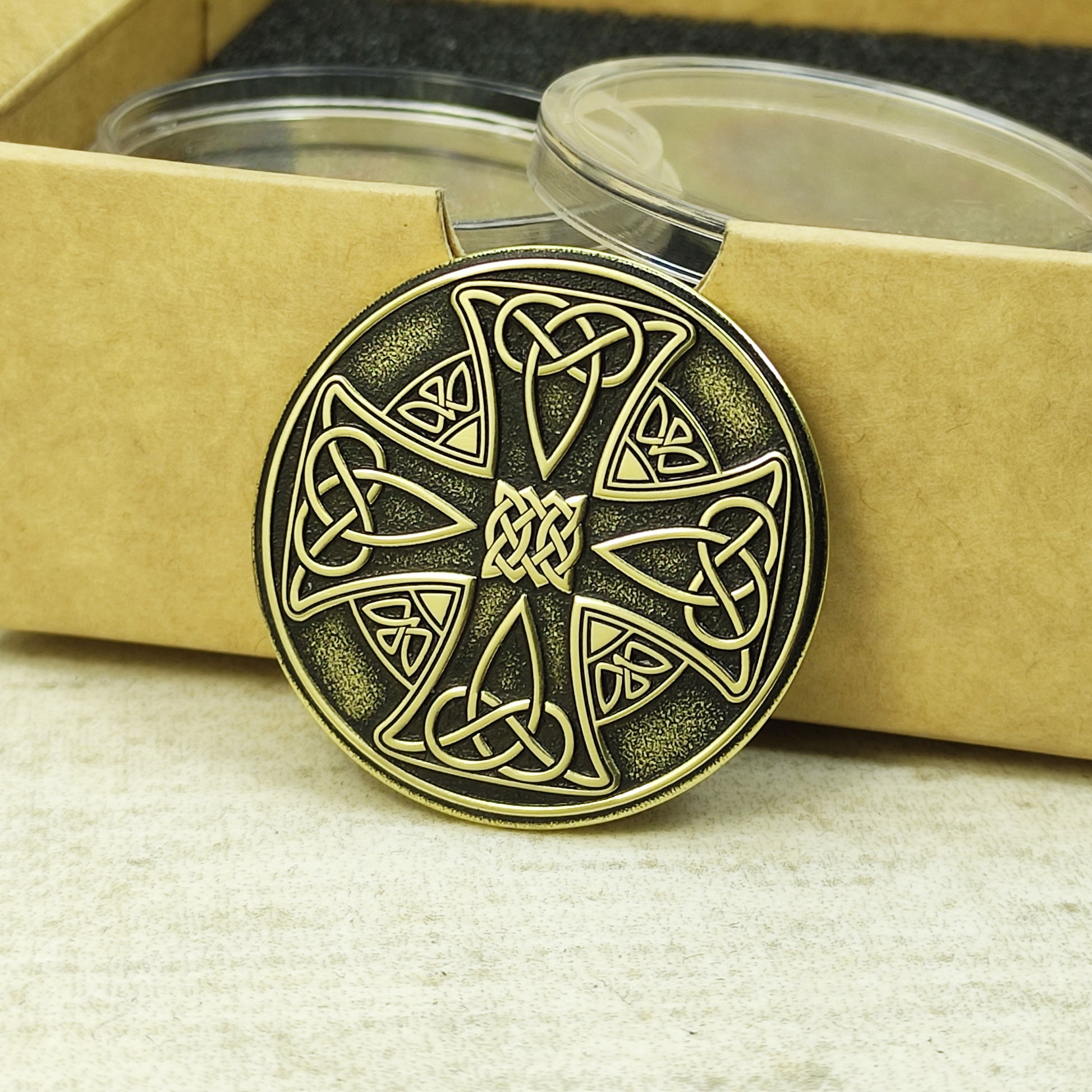 Side view of a 2mm thick brass Celtic coin, showcasing metallic luster and deep laser engraving precision.