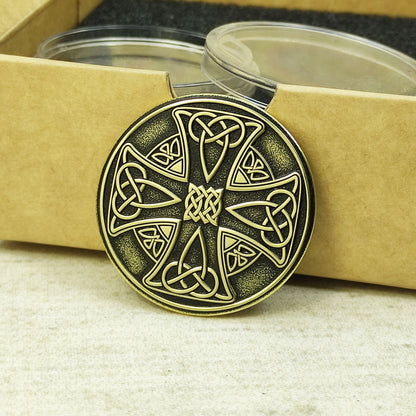 Side view of a 2mm thick brass Celtic coin, showcasing metallic luster and deep laser engraving precision.