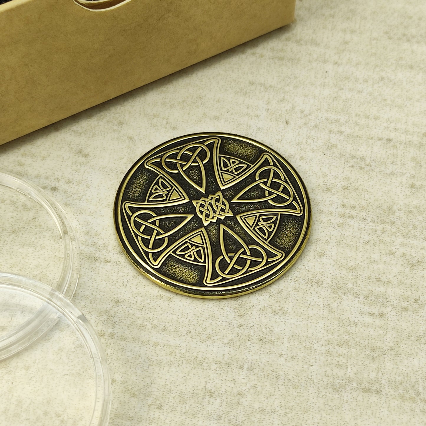 Top view of a personalized brass Celtic cross token, high-contrast antique finish, unique gift for protection.