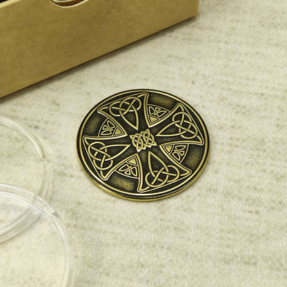 Top view of a personalized brass Celtic cross token, high-contrast antique finish, unique gift for protection.
