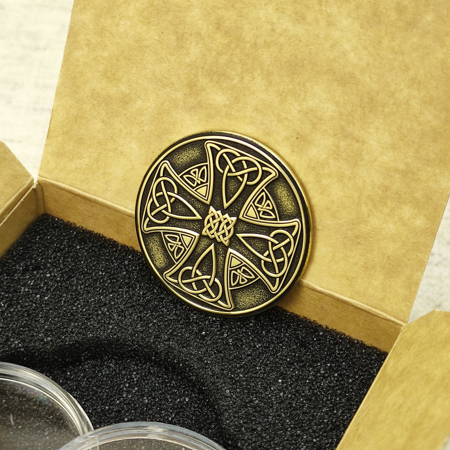 Handmade brass Celtic coin in a premium craft gift box, detailed Norse and Celtic knotwork art.