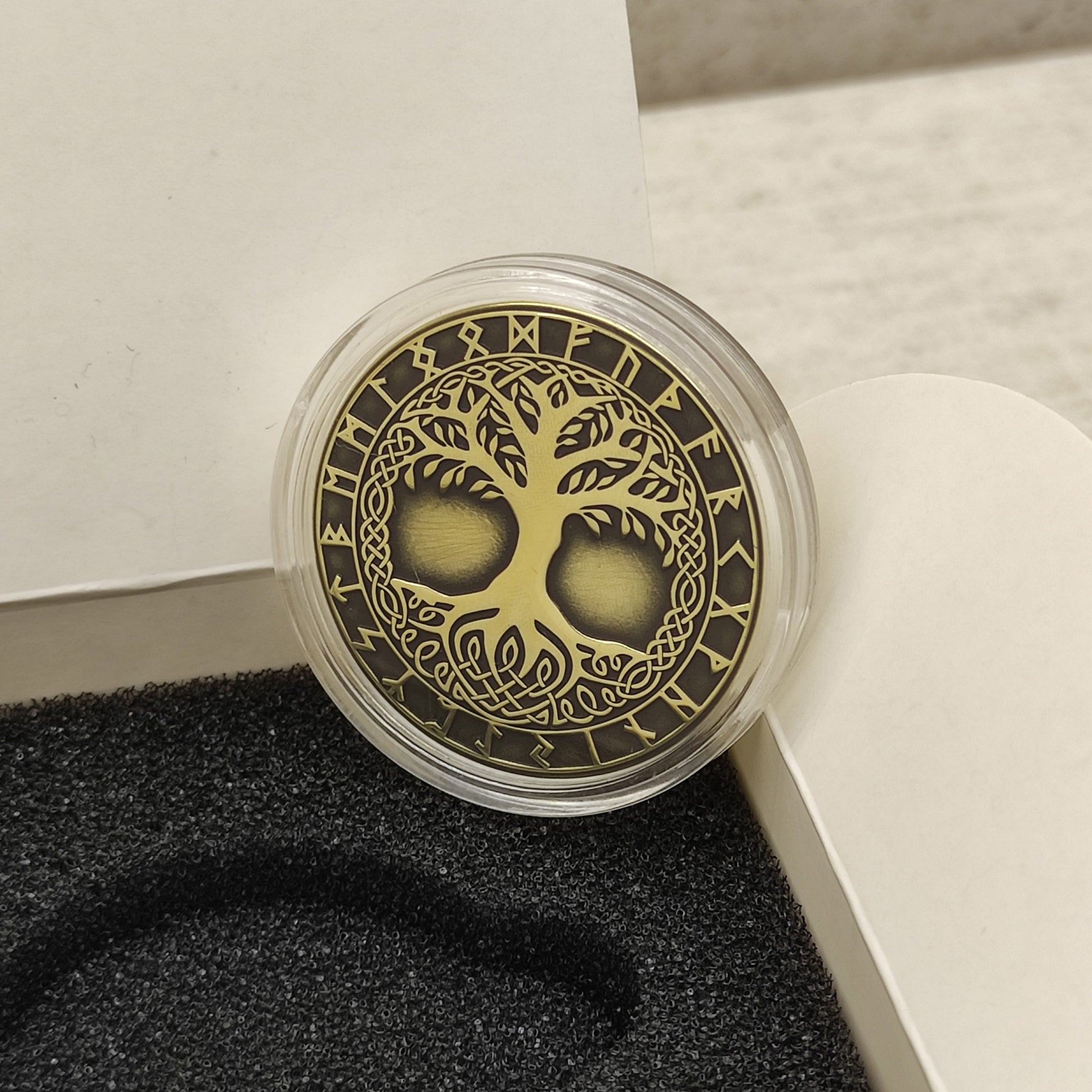Brass Tree of Life souvenir coin in a clear protective acrylic capsule, highlighting the premium polished finish.
