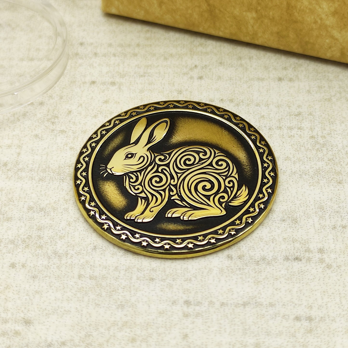 Detailed view of the brass Rabbit zodiac coin with 3D-style floral patterns, showcasing the 32mm diameter and professional deep laser etching.