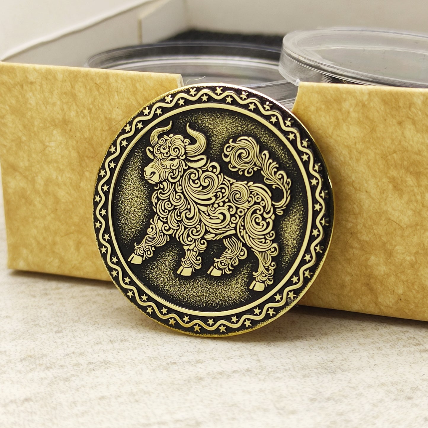 Brass Year of the Ox zodiac coin in a protective acrylic capsule and eco-friendly craft gift box, highlighting the polished brass quality.