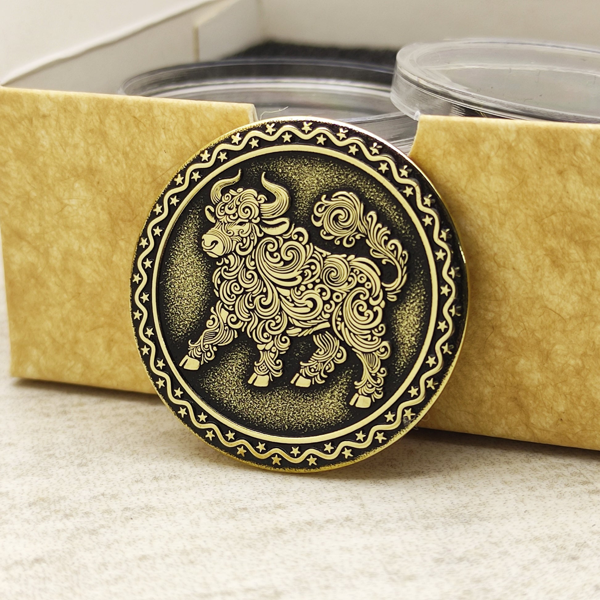 Brass Year of the Ox zodiac coin in a protective acrylic capsule and eco-friendly craft gift box, highlighting the polished brass quality.