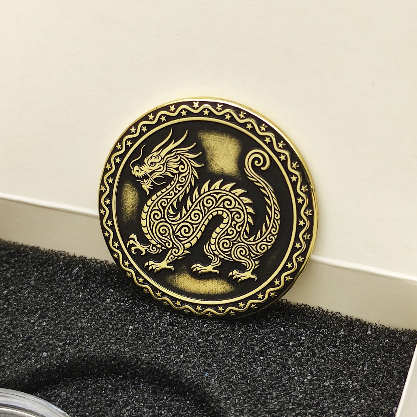 Vertical view of the personalized brass zodiac medal in a premium black insert box, showcasing the antique finish and engraved zodiac details.