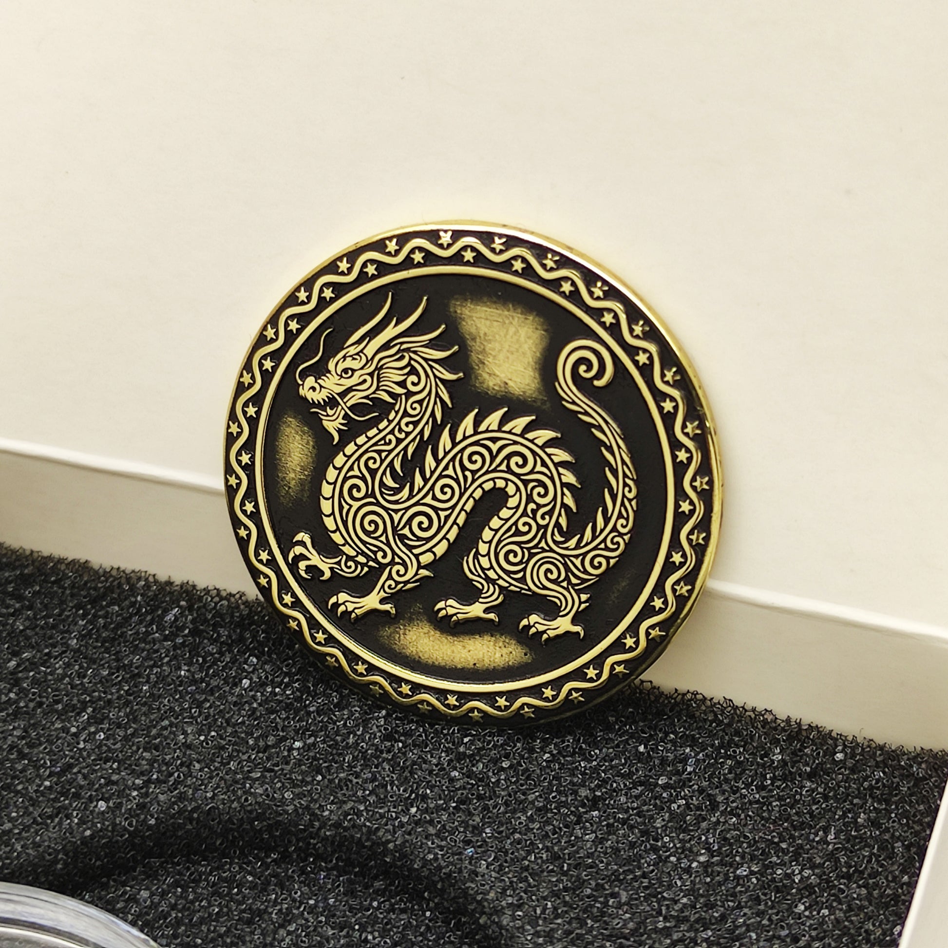 Vertical view of the personalized brass zodiac medal in a premium black insert box, showcasing the antique finish and engraved zodiac details.