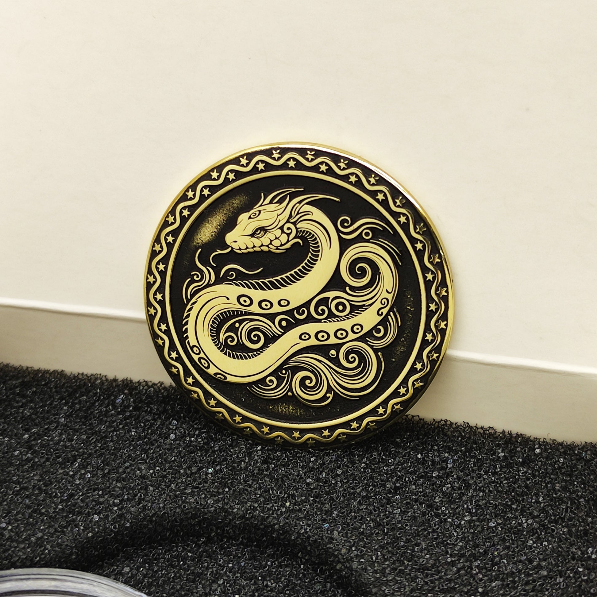 Vertical view of the personalized brass zodiac medal in a premium black insert box, showcasing the antique finish and engraved zodiac details.