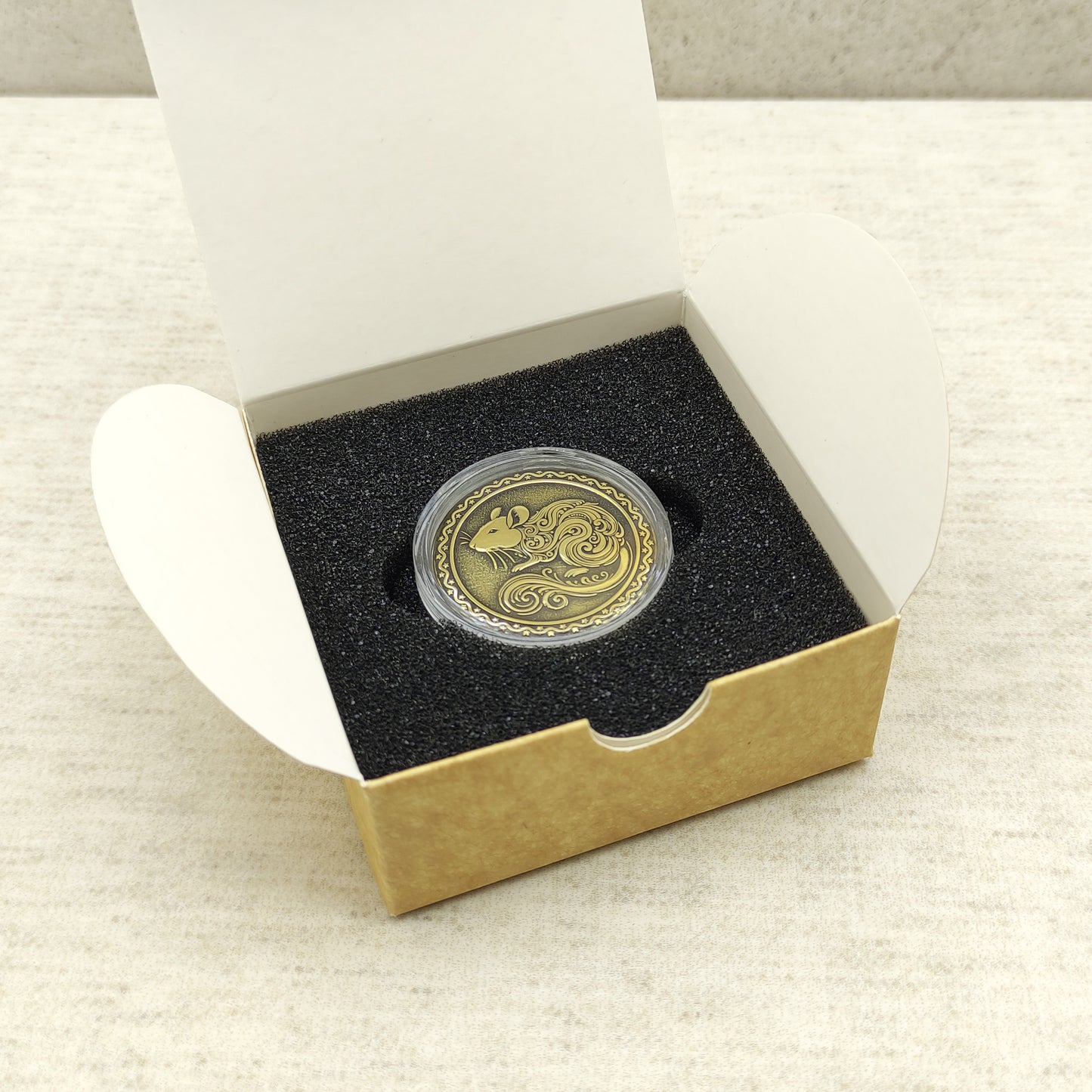 Ready-to-gift personalized brass zodiac medal, handmade Chinese Year of the Rat coin in a square craft box with black foam insert.