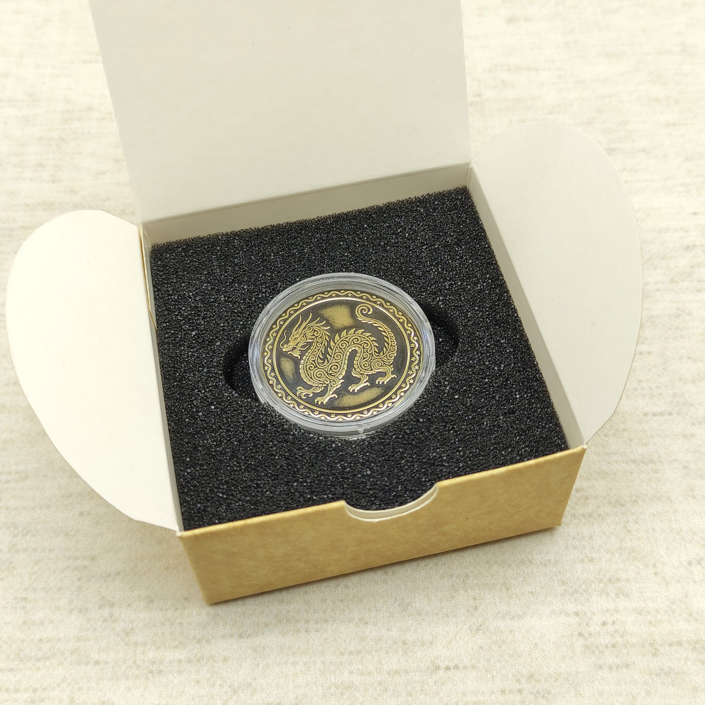Ready-to-gift personalized brass zodiac medal, handmade Chinese Year of the Dragon coin in a square craft box with black foam insert.