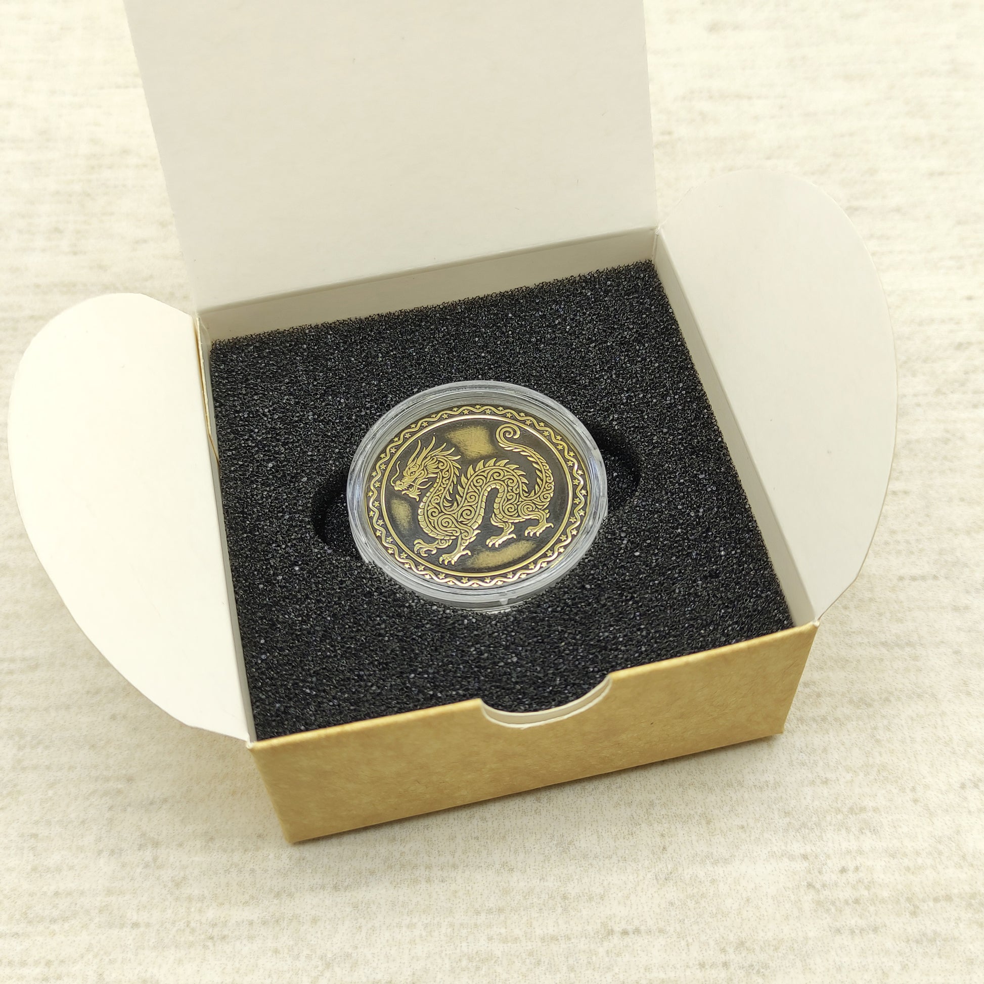 Ready-to-gift personalized brass zodiac medal, handmade Chinese Year of the Dragon coin in a square craft box with black foam insert.