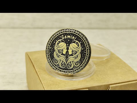 Personalized brass Gemini zodiac coin placed on a craft gift box, showcasing the durable metal texture and high-contrast professional patina treatment.