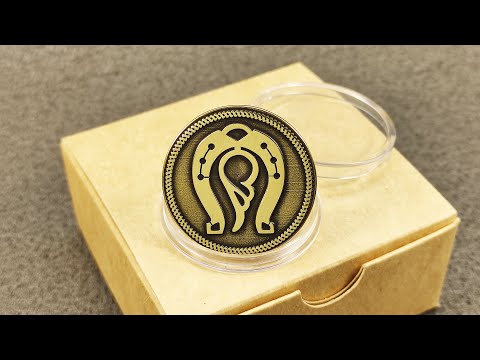 Personalized brass lucky charm coin with horseshoe and wing design, displayed on a craft gift box background.