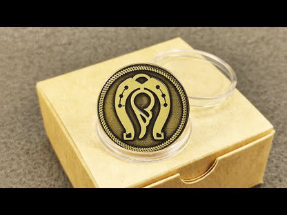 Personalized brass lucky charm coin with horseshoe and wing design, displayed on a craft gift box background.