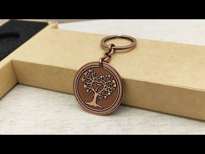 Side view of personalized copper anniversary coin keychain showing metal thickness and vintage oxidized texture on a gift box.
