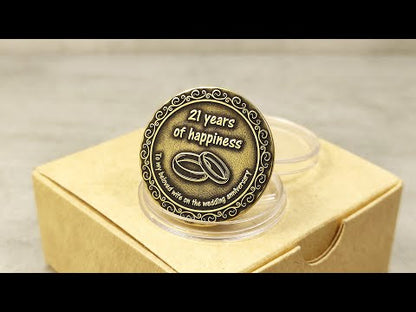 Product video of custom engraved brass anniversary coin for 21 years of marriage in a premium kraft paper gift box.