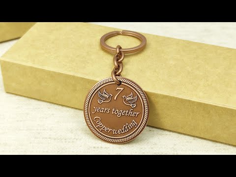 Personalized 7th anniversary copper gift keychain with laser engraved doves and dark aged finish.