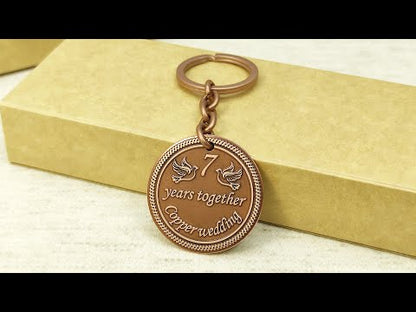 Personalized 7th anniversary copper gift keychain with laser engraved doves and dark aged finish.