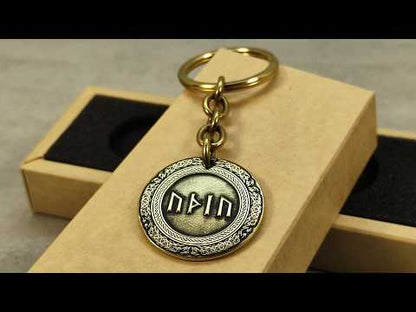 Video showcase of a personalized brass rune keychain, highlighting the metallic texture and high-contrast professional patina treatment.