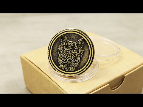 Personalized brass anniversary coin for 21st wedding gift, displayed in a clear holder against a craft paper box.