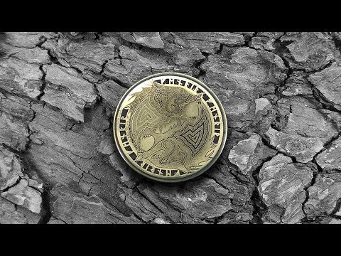 Double Fenrir Wolf brass amulet with runic engraving on a natural bark background, authentic Viking souvenir with aged patina.